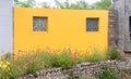 A beautiful curved yellow wall with two windows signature of Buddhist monasty architecture. Buddhism and Zen concept