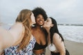 Beautiful curvy women taking a selfie at the beach