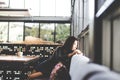 Beautiful cute asia girl in the cafe near the window with coffee smiling and relax, vintage tone. Royalty Free Stock Photo