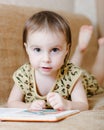 Beautiful cute baby reading a book Royalty Free Stock Photo