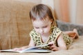 Beautiful cute baby reading a book Royalty Free Stock Photo