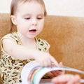 Beautiful cute baby reading a book Royalty Free Stock Photo