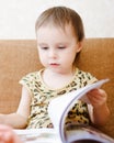 Beautiful cute baby reading a book Royalty Free Stock Photo