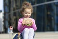 Beautiful cute child with appetite eating fast food, portrait. happy girl biting homemade sandwich. Royalty Free Stock Photo