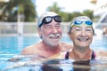 Beautiful and cute close up of two seniors in the pool having fun together - fitness and healthy lifestyle - summertime together Royalty Free Stock Photo