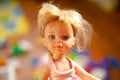 Beautiful and cute face of a children doll with blond hair portrait Royalty Free Stock Photo