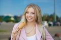 Beautiful cute funny amazing young hipster teen girl eating ice cream cone, laughs happy, bright casual wear, urban Royalty Free Stock Photo