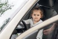 Beautiful cute little girl driving a car