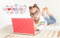 Beautiful cute little girl laying on carpet and using laptop computer at home Royalty Free Stock Photo
