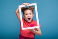 Beautiful cute little girl in pink dress holds picture frame Royalty Free Stock Photo