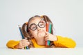 Beautiful cute little preschooler girl holding colorful pencils and making gesture while looking at cameraBeautiful cute little pr Royalty Free Stock Photo