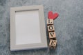 Beautiful cute lovely white pastel frame with wood cube LOVE letter on black background. Photo for couple and lover or family and Royalty Free Stock Photo