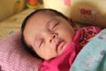 Indian asian small baby smile in sleep Royalty Free Stock Photo