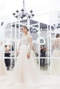 Beautiful cute tender young girl bride in wedding dress in mirrors with evening hair and gentle light make-up Royalty Free Stock Photo