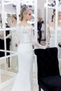 Beautiful cute tender young girl bride in wedding dress in mirrors with evening hair and gentle light make-up Royalty Free Stock Photo