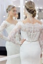 Beautiful cute tender young girl bride in wedding dress in mirrors with evening hair and gentle light make-up Royalty Free Stock Photo