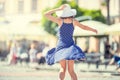 Beautiful cute young girl dancing on the street from happiness.Cute happy girl in summer clothes dancing in the sun Royalty Free Stock Photo