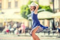 Beautiful cute young girl dancing on the street from happiness.Cute happy girl in summer clothes dancing in the sun Royalty Free Stock Photo