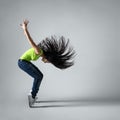 Beautiful dancer girl squatting with flying hair