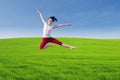Beautiful dancer jumping above green field Royalty Free Stock Photo