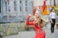 Beautiful dancer in a red dress. Beautiful young girl dancing in a red dress. Dance in public. Talented kid does dancing