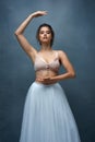 Beautiful dancer. Studio shot of an attractive young female ballet dancer posing against a grey background. Royalty Free Stock Photo