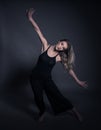 Beautiful dancer - young woman dance over dark gray background Royalty Free Stock Photo