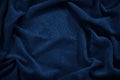 Beautiful dark blue fabric background. Wavy soft folds. Elegant navy blue background Royalty Free Stock Photo