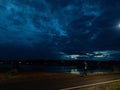 Beautiful dark blue sky , river with reflection of sky and a lonely road