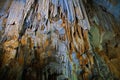 Beautiful dark cave interior with ancient stalactites and stalagmites. Horizontal image Royalty Free Stock Photo