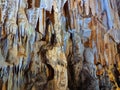 Beautiful dark cave interior with ancient stalactites and stalagmites. Wild nature. Horizontal image Royalty Free Stock Photo