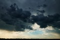 Beautiful dark dramatic sky with sunlight and clouds as a background