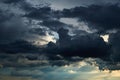 Beautiful dark dramatic sky with sunlight and clouds as a background