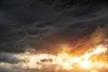 Beautiful dark fluffy cloudy sky with sun rays. Sunset light Royalty Free Stock Photo