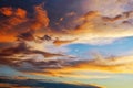 Beautiful dark fluffy cloudy sky. Sunset light Royalty Free Stock Photo