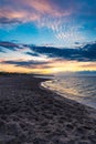 Beautiful dark golden sunset at golden hour at the beach next to dark and cold sea at summer right after the storm Royalty Free Stock Photo