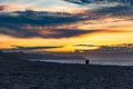 Beautiful dark golden sunset at golden hour at the beach next to dark and cold sea at summer right after the storm Royalty Free Stock Photo