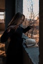 Girl sorceress leafing through a book of spells Royalty Free Stock Photo