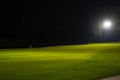 Beautiful dark night view of the golf course, Bunkers sand and green grass, garden background In the light of the spotlight undere Royalty Free Stock Photo