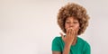 Beautiful dark-skinned woman in a green t-shirt sends an air kiss touches her lips with her hand Royalty Free Stock Photo