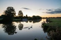 Beautiful dawn landscape image of River Thames at Lechlade-on-Thames in English Cotswolds countryside with swan in misty river Royalty Free Stock Photo