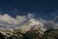 Beautiful dawn view of the snowy peak of Mount Kazbek and the Church of the Holy Trinity. The village of Kazbegi Stepantsminda is Royalty Free Stock Photo