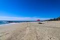 A beautiful day on a gorgeous sandy beach with people relaxing on the beach with blue sky Royalty Free Stock Photo