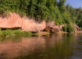 day on the river, sandstone cliffs and tree reflections in the water, blue sky reflected in the river water Royalty Free Stock Photo