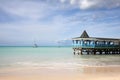 Beautiful day with a view out to sea & the pier of Runaway Beach, Antigua, Caribbean