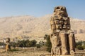 Beautiful daytime view of the Colossi of Memnon. Two large stone figures depicting a seated pharaoh. Royalty Free Stock Photo