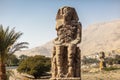 Beautiful daytime view of the Colossi of Memnon. Two large stone figures depicting a seated pharaoh. Royalty Free Stock Photo