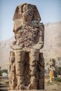 Beautiful daytime view of the Colossi of Memnon. Two large stone figures depicting a seated pharaoh. Royalty Free Stock Photo