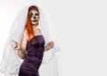 Beautiful dead bride with terrible mask painted on her face. Halloween and creative make-up. Royalty Free Stock Photo