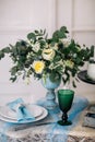 Beautiful decorate table with candles, vase with flowers and wedding cake on the table in studio Royalty Free Stock Photo